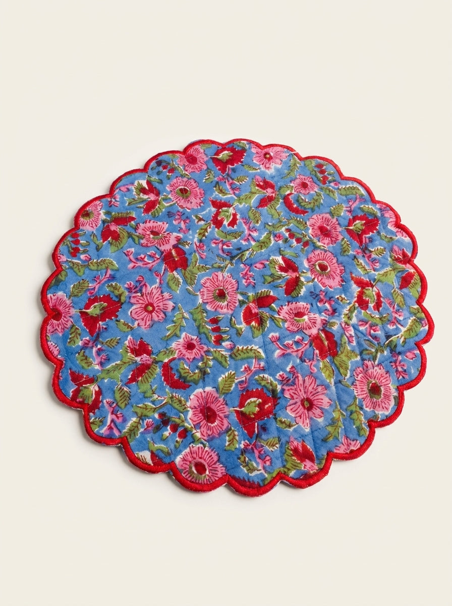 Berry Meadow quilted cotton placemat with pink and red flowers on blue and scalloped red edging
