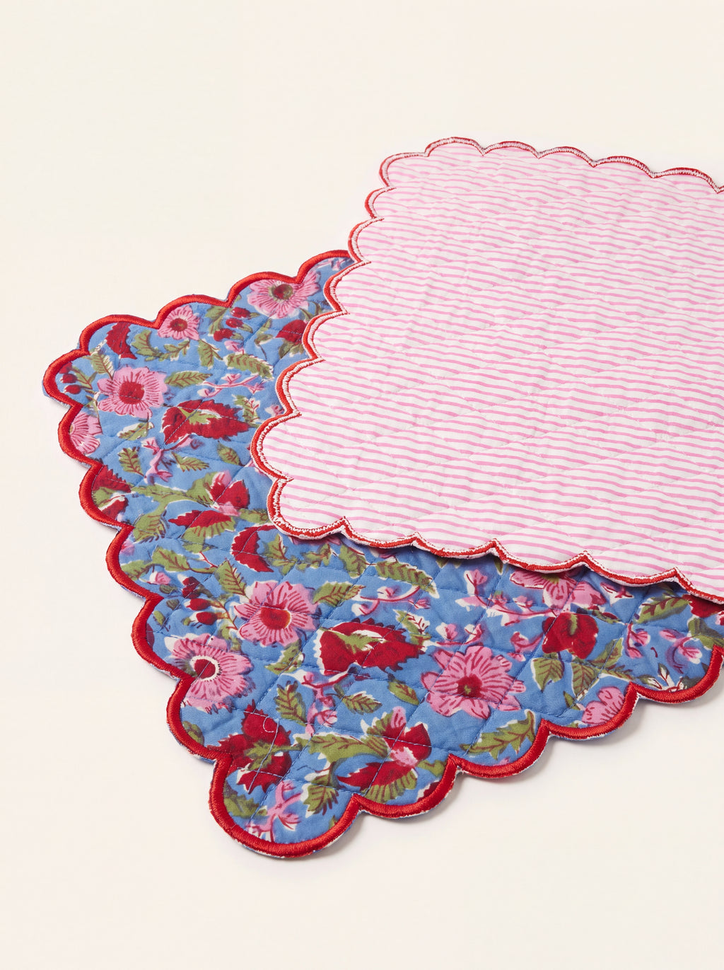Reverse of Berry Meadow cotton table runner showing pink striped backing and red scalloped edge
