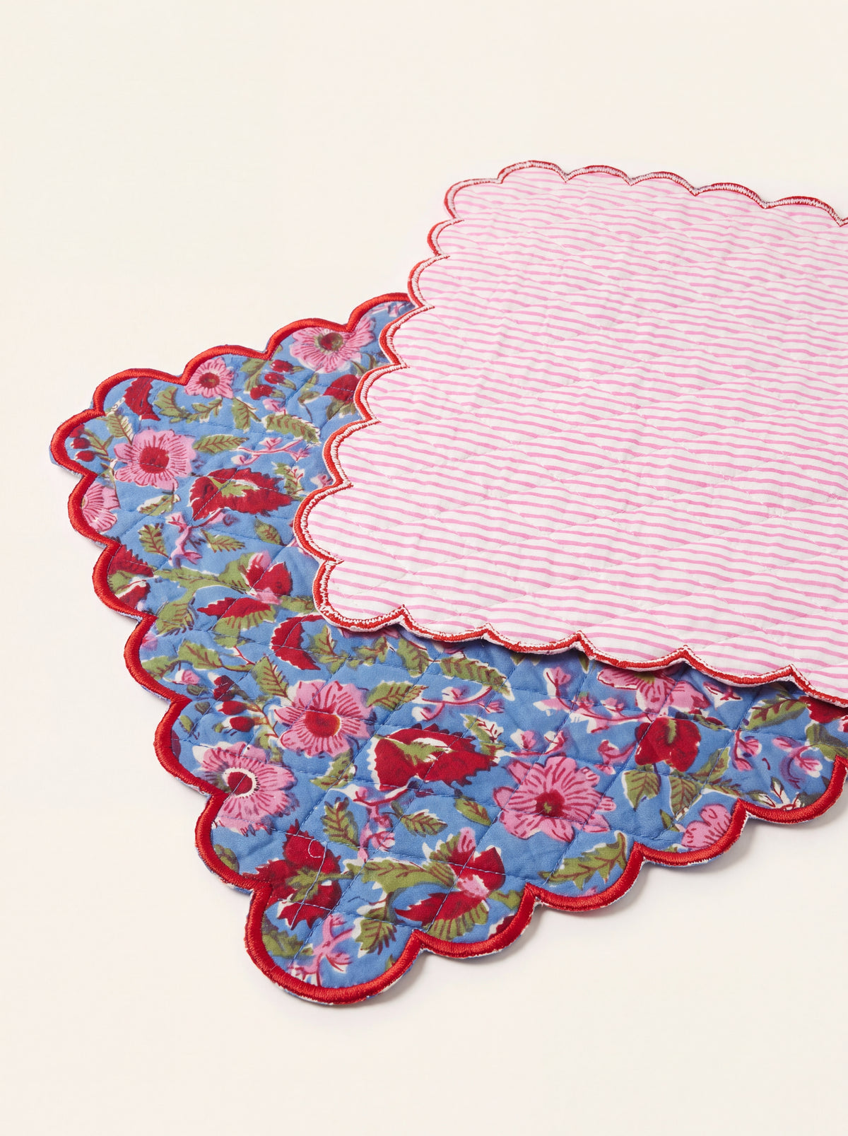 Reverse of Berry Meadow cotton table runner showing pink striped backing and red scalloped edge