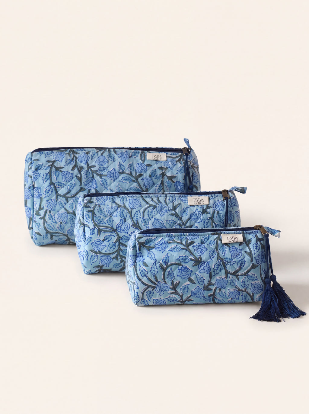 Three Fabalore Blue Bloom quilted floral pouches in small, medium and large sizes.