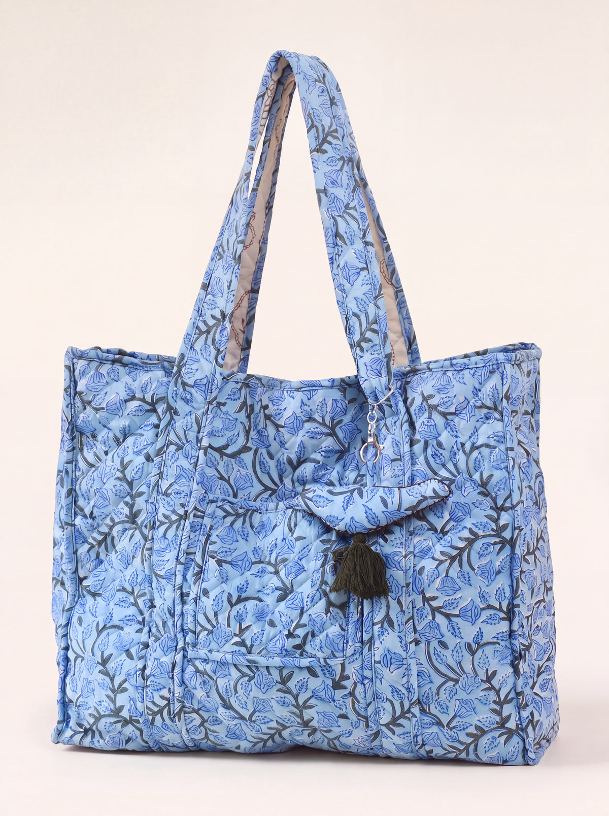 Blue Bloom quilted cotton tote with blue floral print, exterior pocket and tassel charm