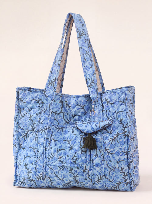 Blue Bloom quilted cotton tote with blue floral print, exterior pocket and tassel charm