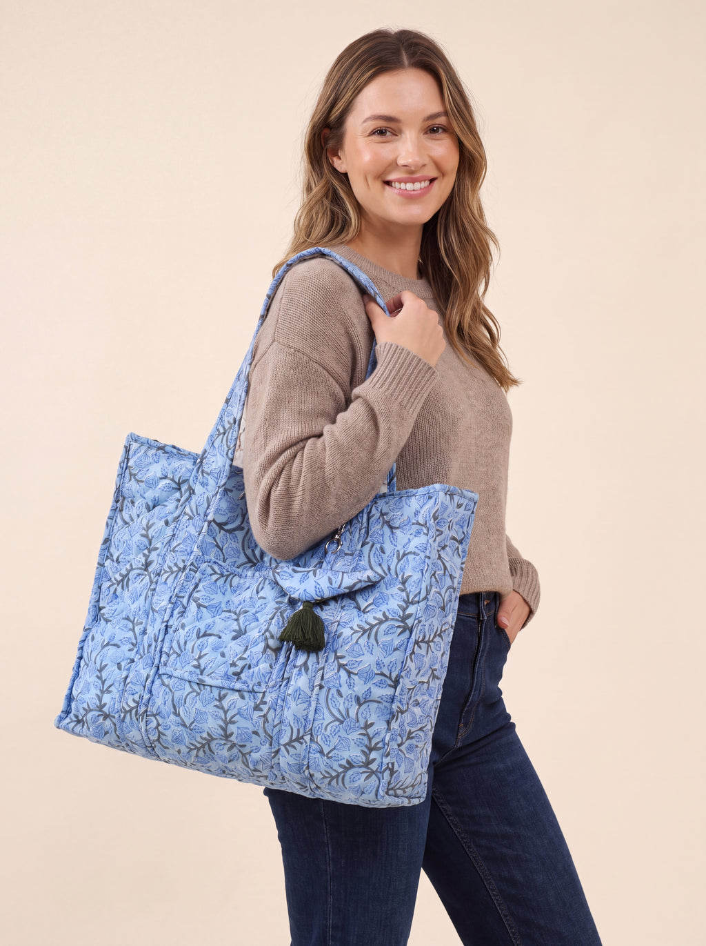 Woman carrying the Blue Bloom quilted cotton tote bag over her shoulder