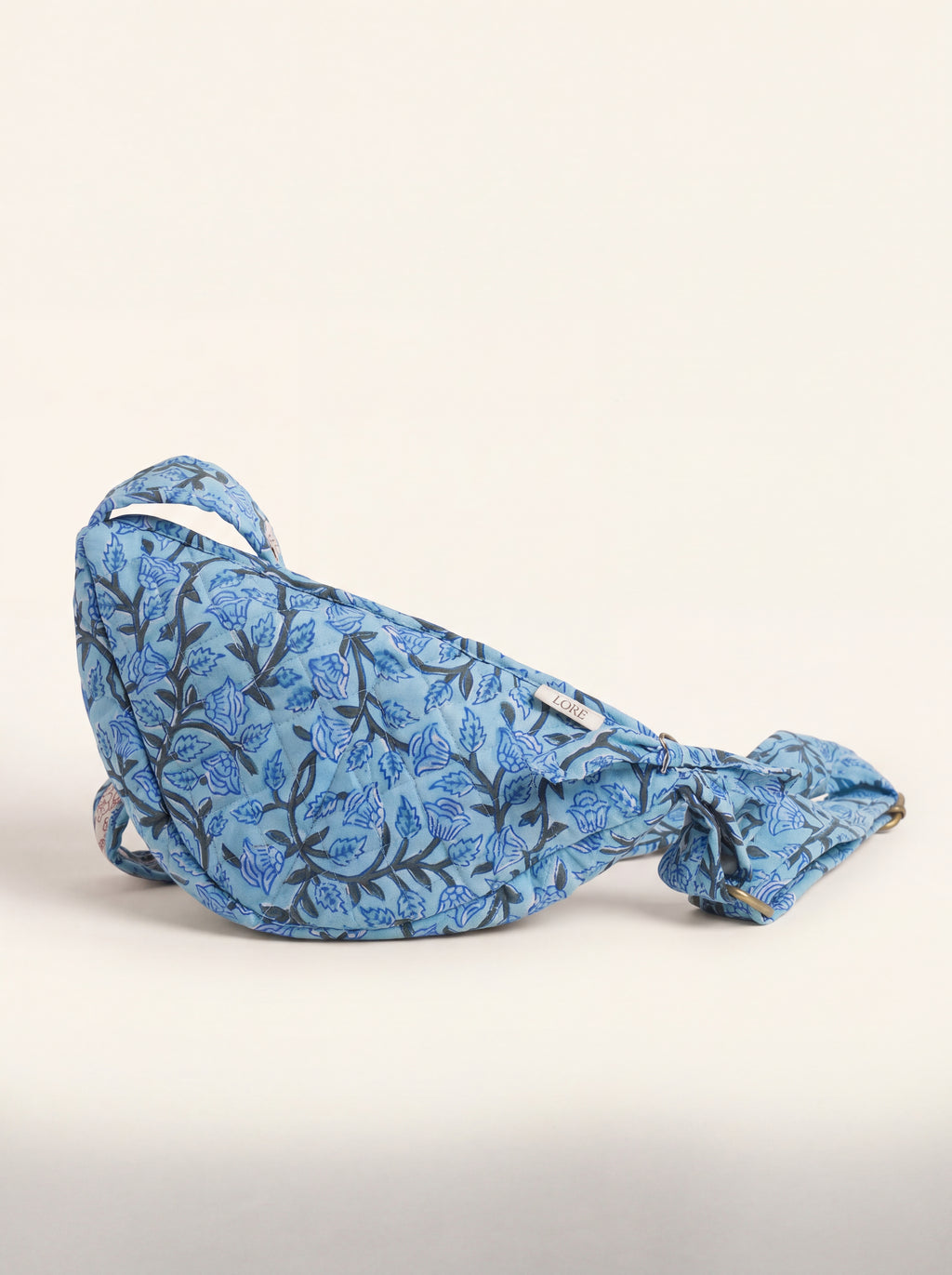 Fabalore Blue Bloom quilted floral sling bag with adjustable strap in blue and white.