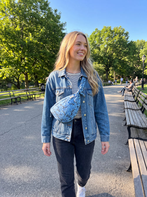 Woman wearing the Fabalore Blue Bloom quilted floral sling bag crossbody outdoors.