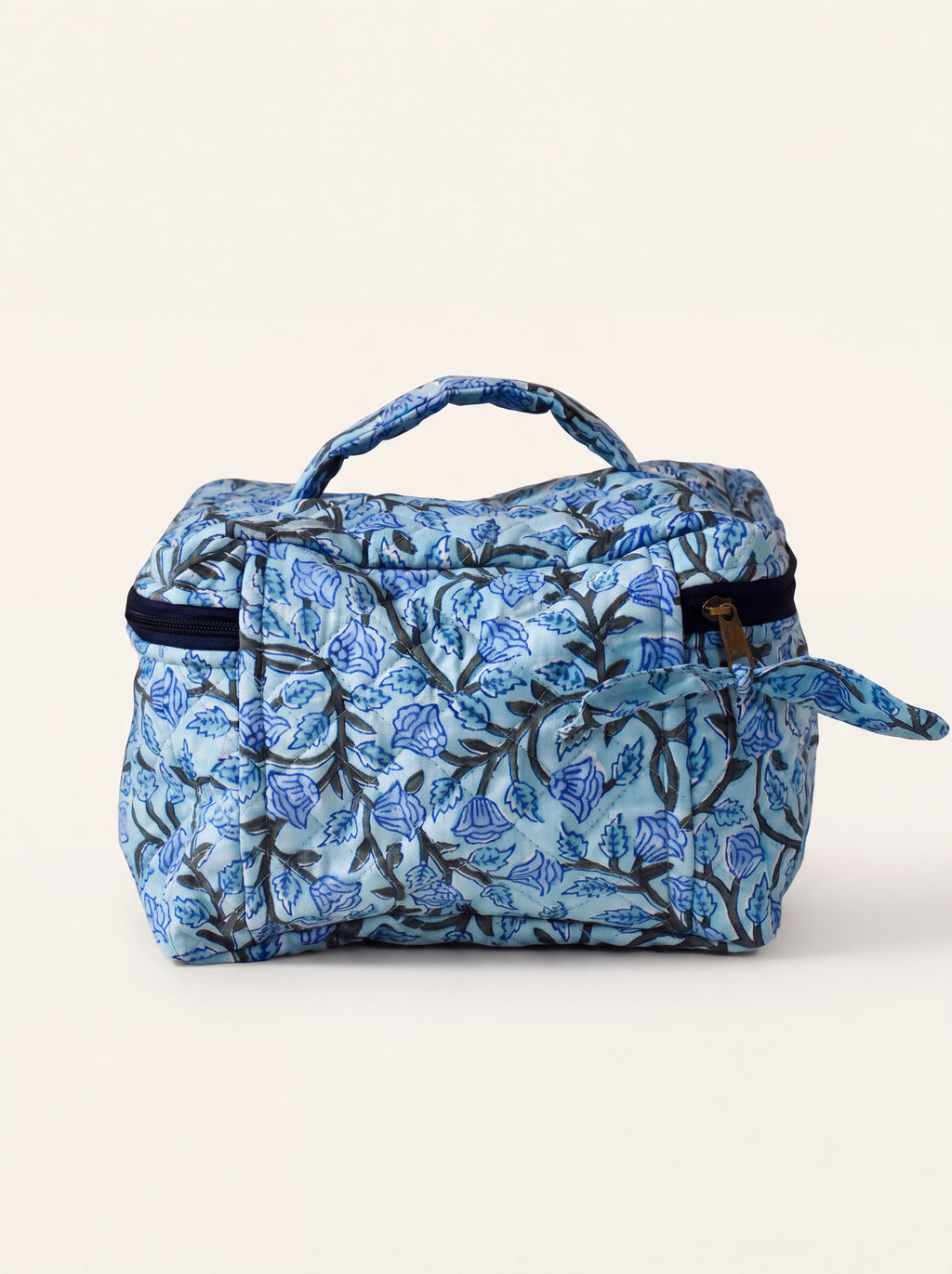 Fabalore Blue Bloom quilted toiletry case with blue floral vine print and top carry handle.