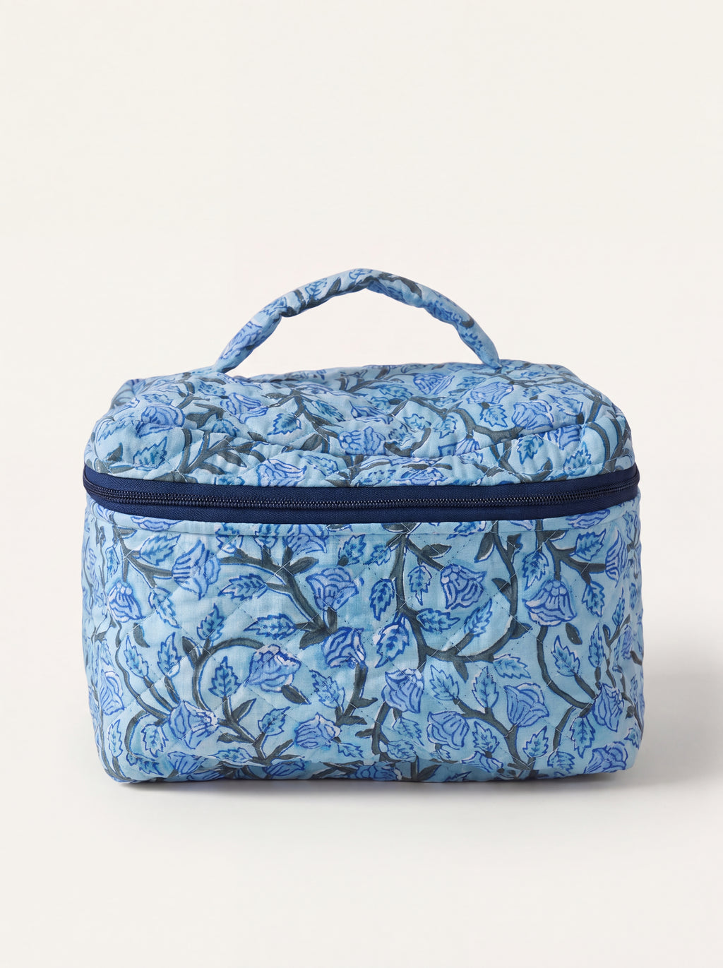 Fabalore Blue Bloom quilted vanity case with blue floral print, top handle and zip-around closure.