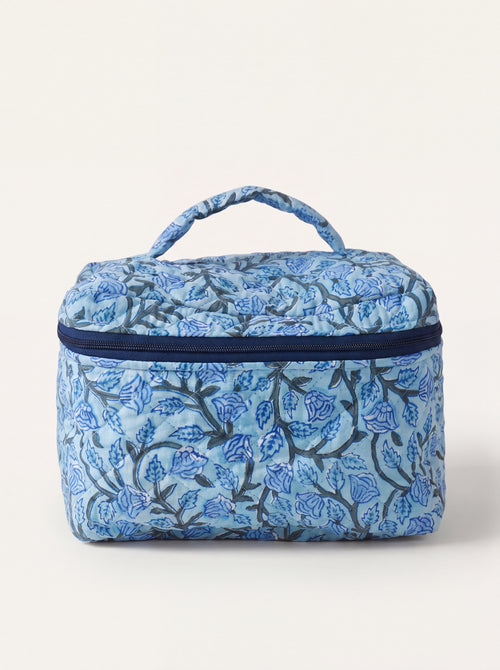 Fabalore Blue Bloom quilted vanity case with blue floral print, top handle and zip-around closure.
