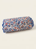 Coral Garden quilted cotton table runner folded to show blue scalloped edging and coral floral block print