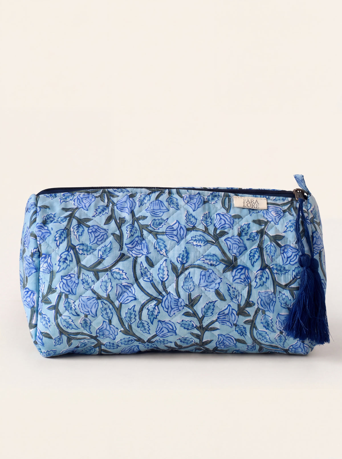 Large Fabalore Indigo Bloom quilted floral pouch with navy zipper and tassel.