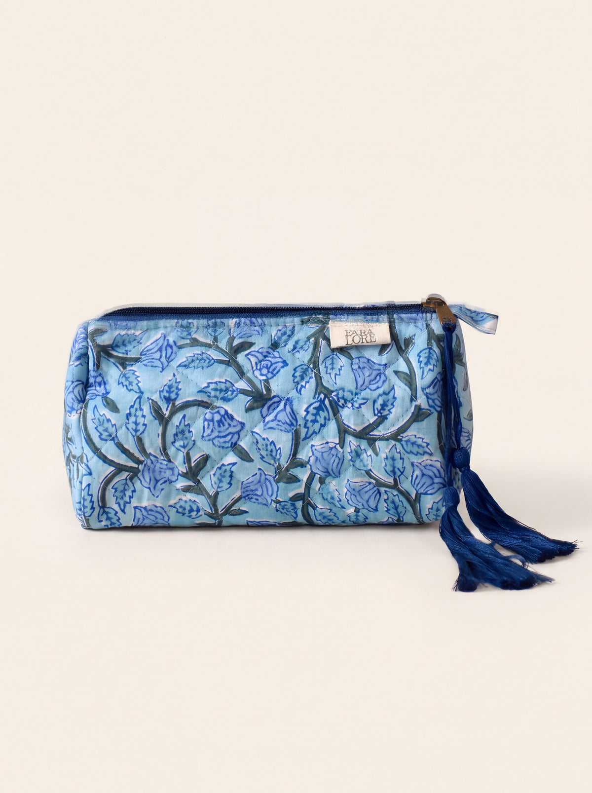 Small Fabalore Indigo Bloom quilted floral pouch with navy zipper and tassel.