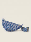Fabalore Indigo Bloom quilted floral sling bag in blue and white with adjustable strap.