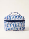 Fabalore Indigo Bloom quilted vanity case with blue floral print, top handle and zip-around closure.