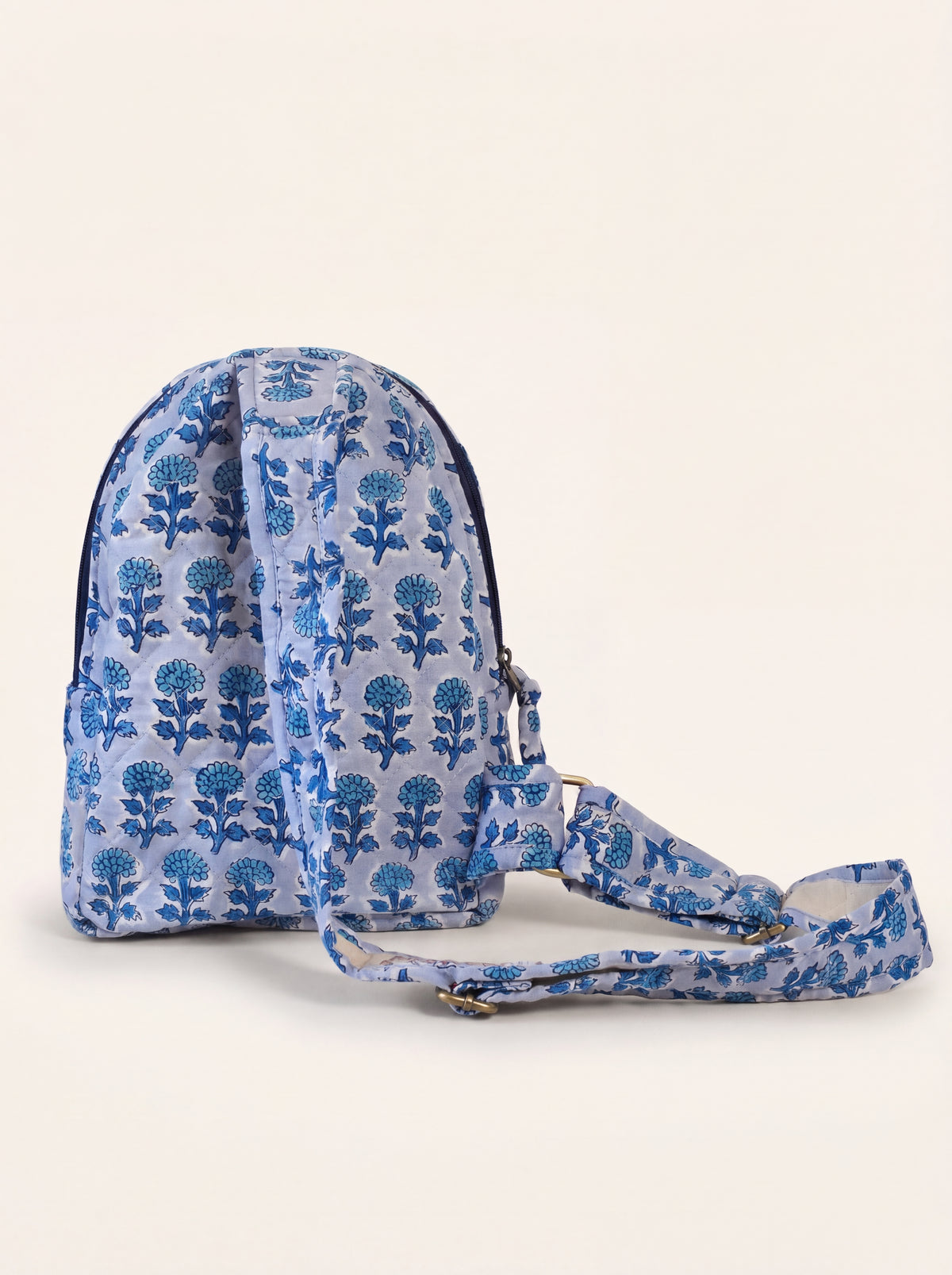 Back view of the Fabalore Indigo quilted backpack showing the adjustable cotton strap and blue floral print.