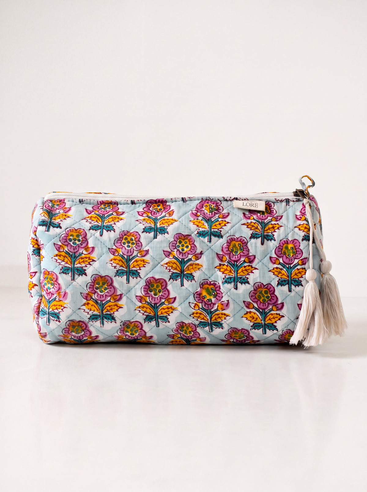 Medium Fabalore Marigold Bloom quilted floral pouch with cream zipper and tassels
