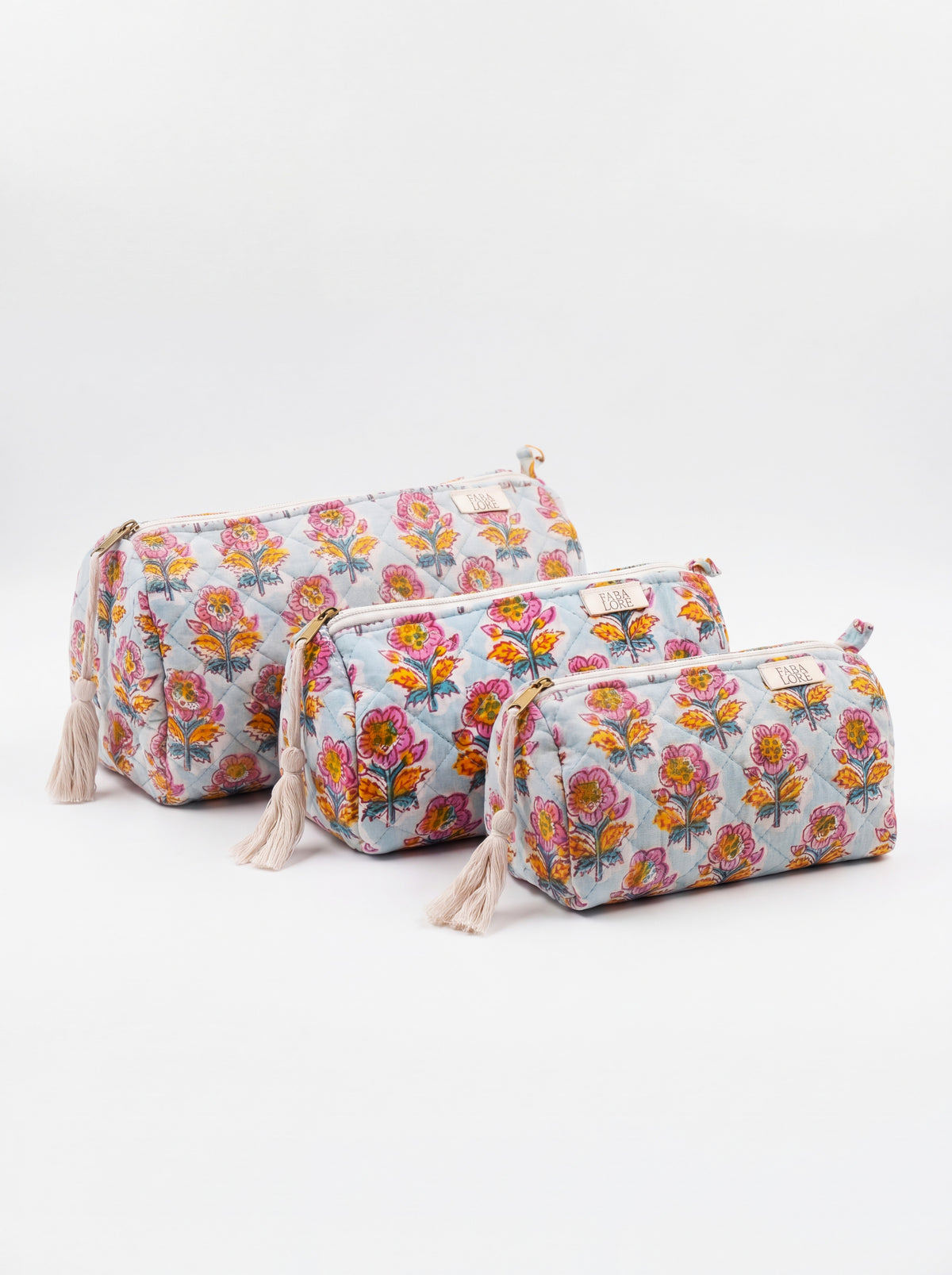 Three Fabalore Marigold Bloom quilted floral pouches in small, medium and large sizes.