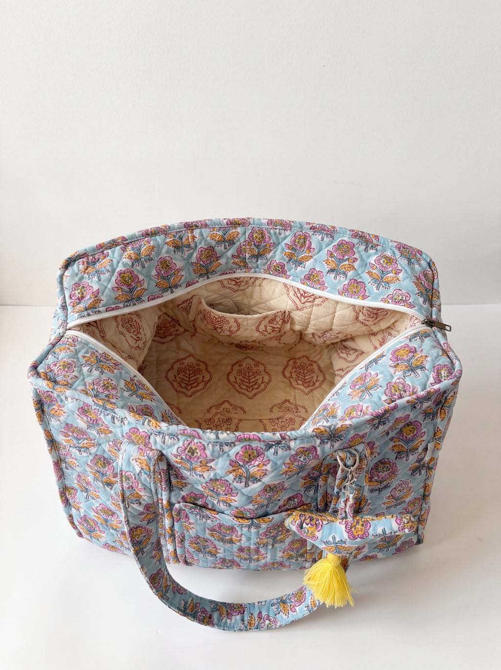 Open Fabalore Marigold Bloom quilted tote showing spacious lined interior, zip closure and interior pockets.