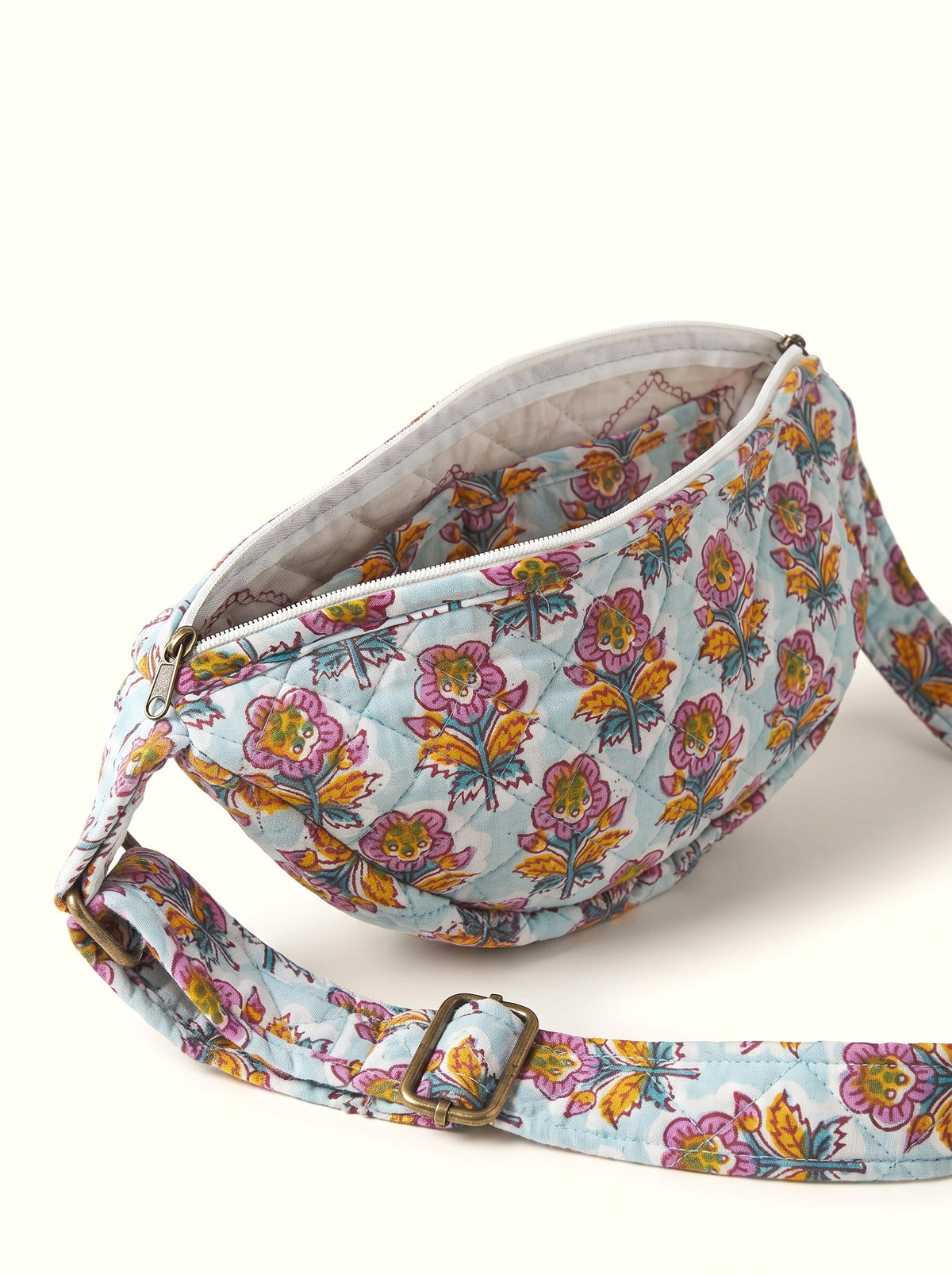Open Fabalore Marigold Bloom quilted sling bag showing zip closure, lined interior and inner pocket.