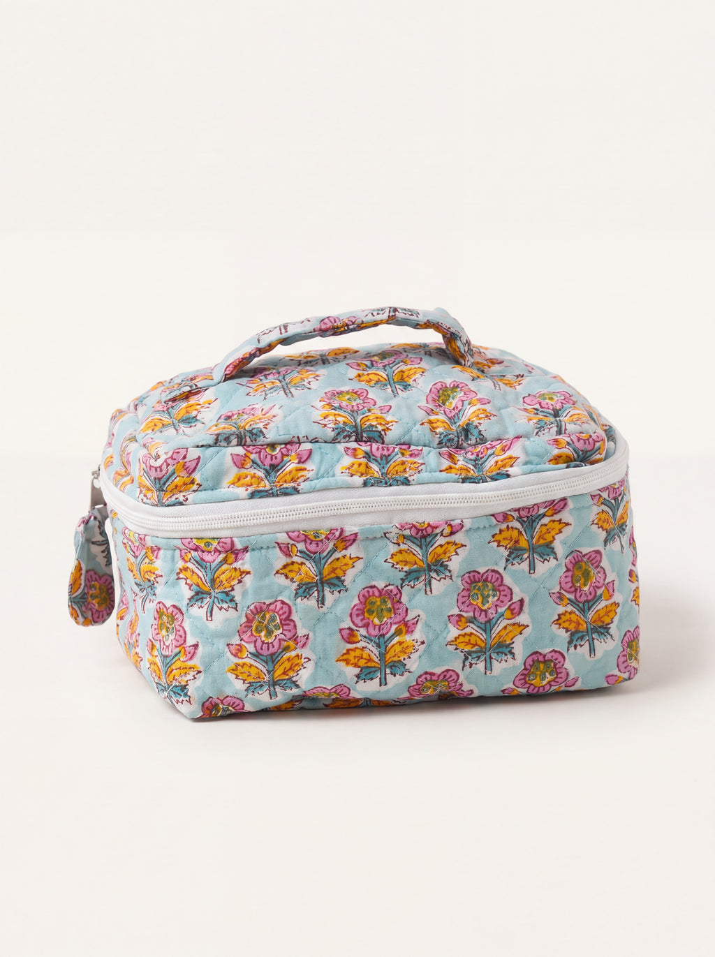 Fabalore Marigold Bloom quilted vanity case with colorful floral print, top handle and zip-around closure.