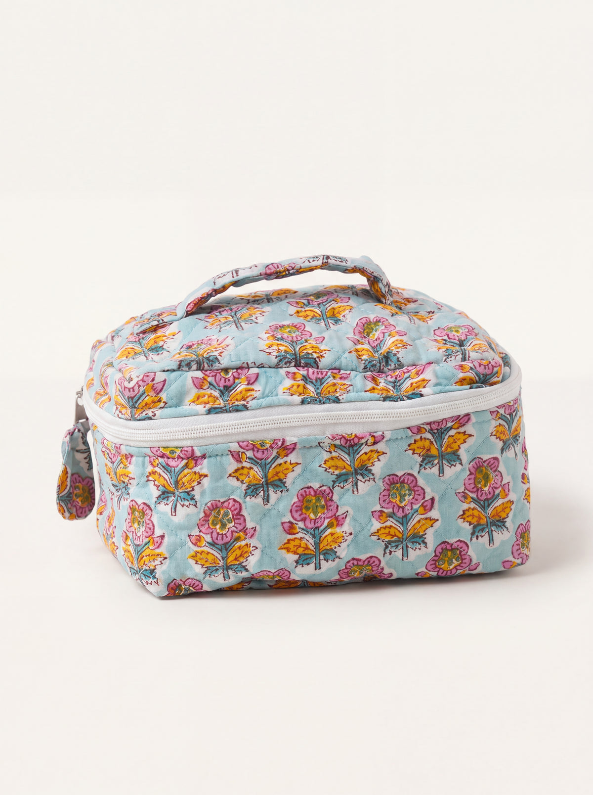 Fabalore Marigold Bloom quilted vanity case with colorful floral print, top handle and zip-around closure.