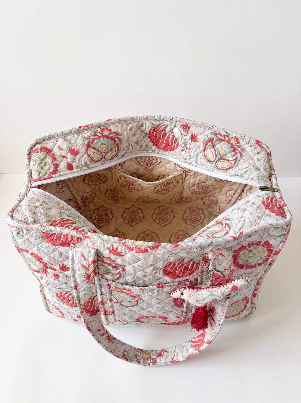 Open Fabalore Meadow quilted tote showing the spacious lined interior, zip-top closure and interior pocket.