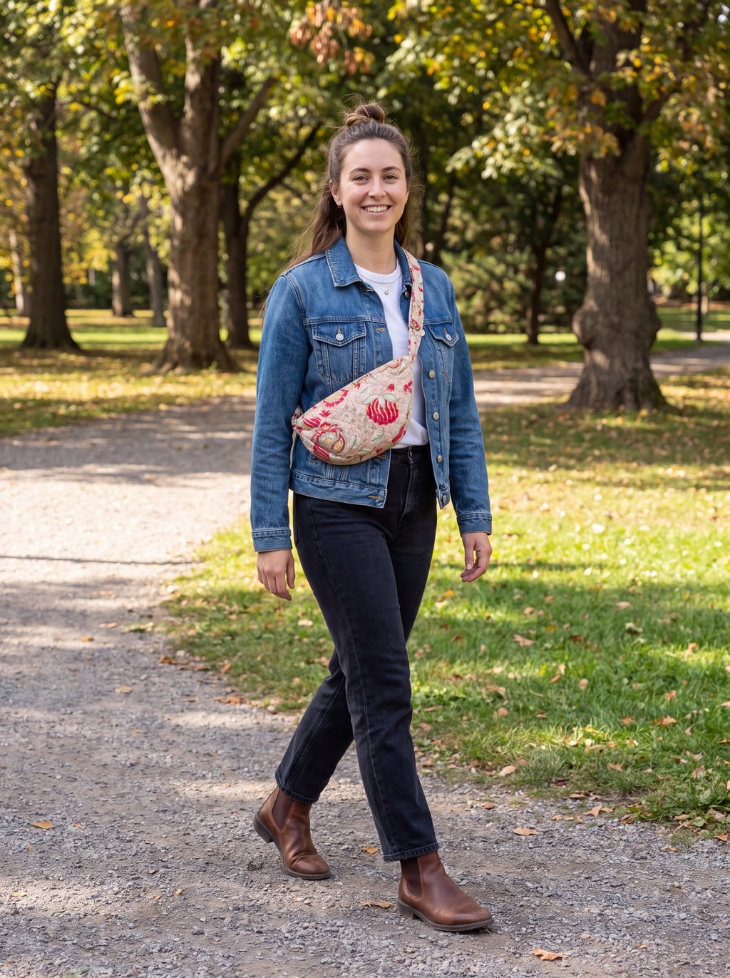 Woman wearing the Fabalore Meadow quilted floral sling bag crossbody while walking outdoors.