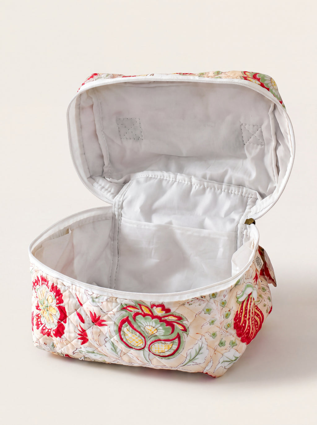 Open Fabalore Meadow quilted vanity case showing lined interior and organizational pockets.