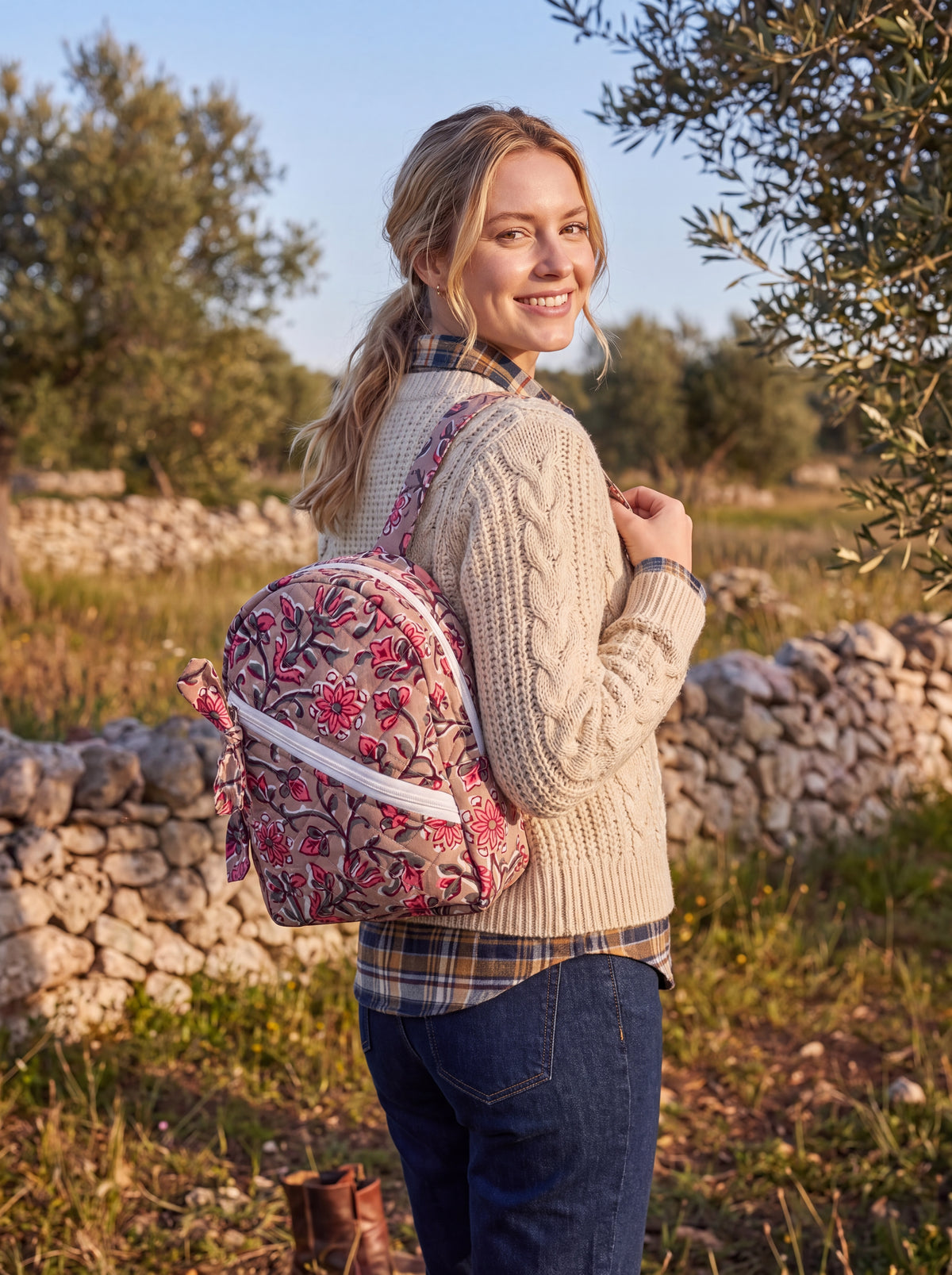 Rosewood quilted backpack worn on the back outdoors, showing its size and fit.