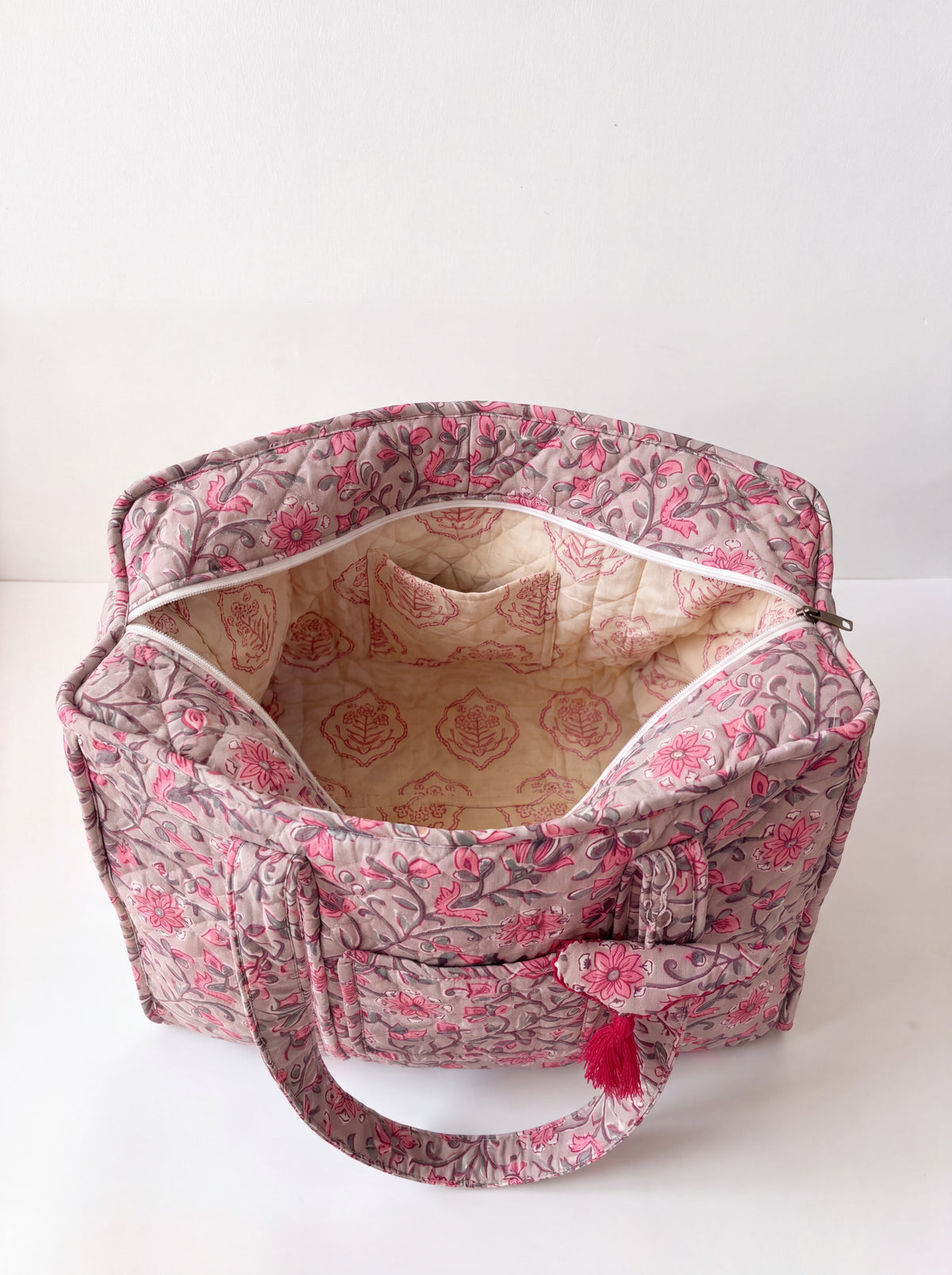 Interior of Rosewood quilted tote bag showing zip closure and inner pocket