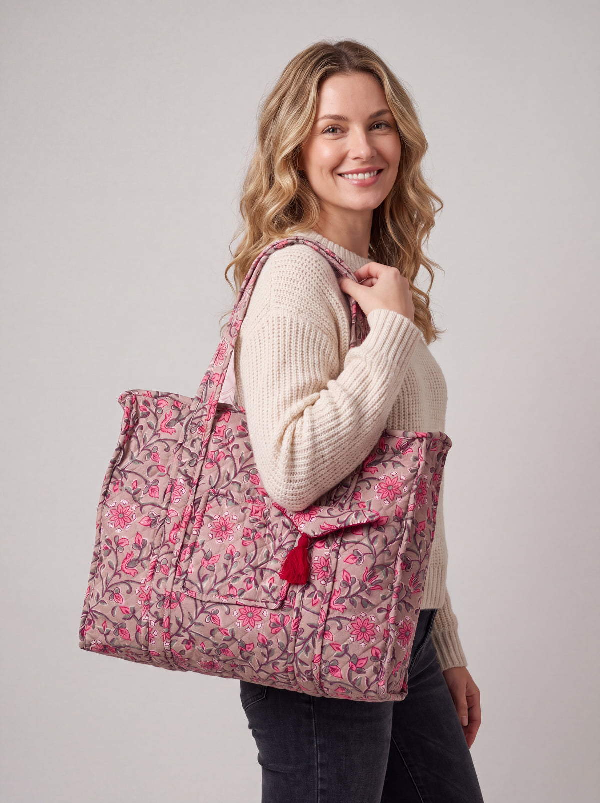 Woman carrying the Rosewood quilted floral tote bag over her shoulder