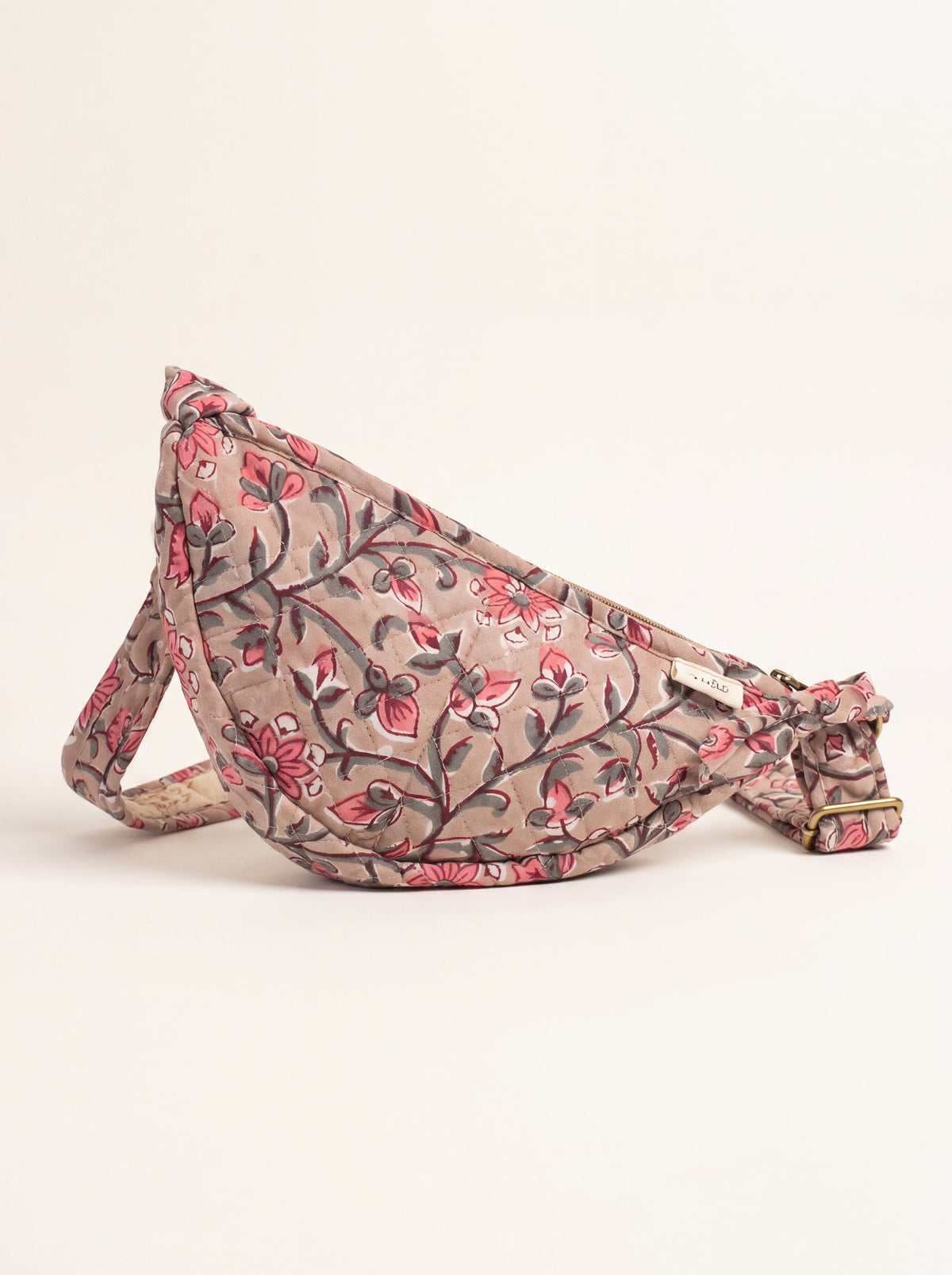 Fabalore Rosewood quilted floral sling bag in dusty rose and pink with adjustable strap.