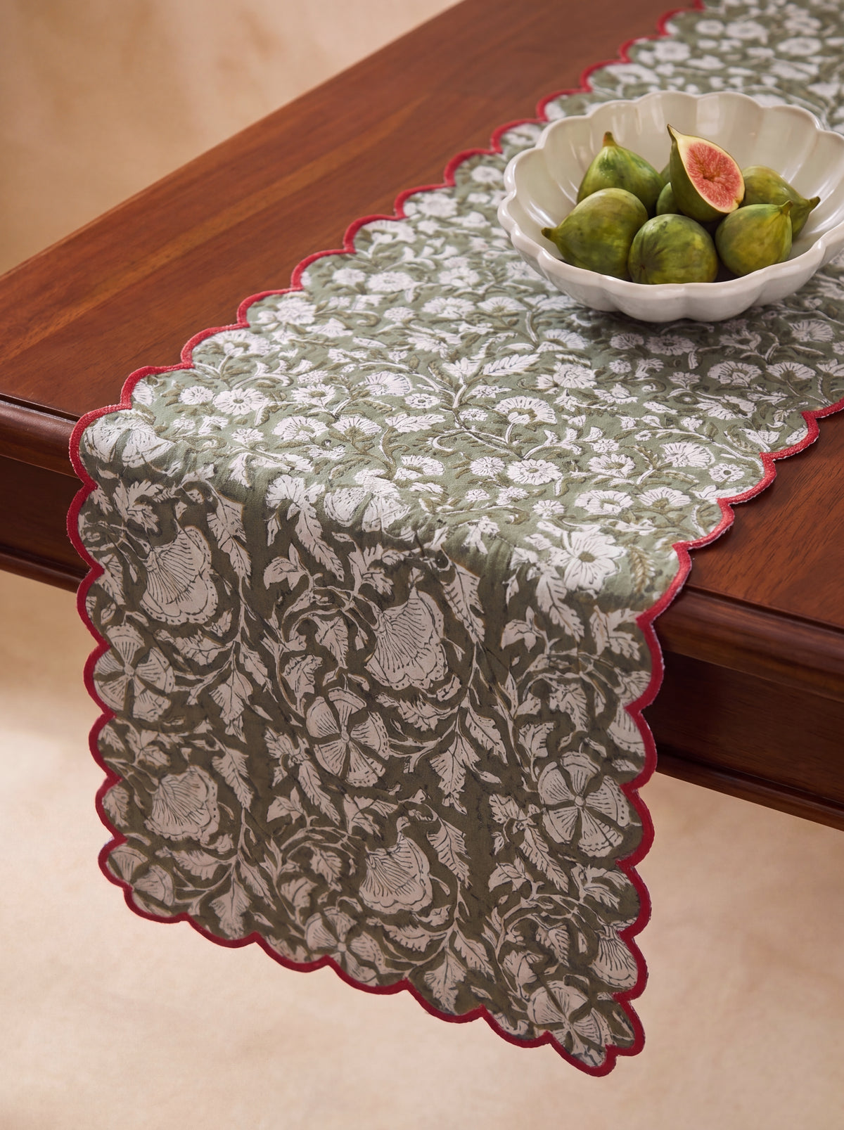 Close-up of olive and cream botanical block print on quilted cotton table runner